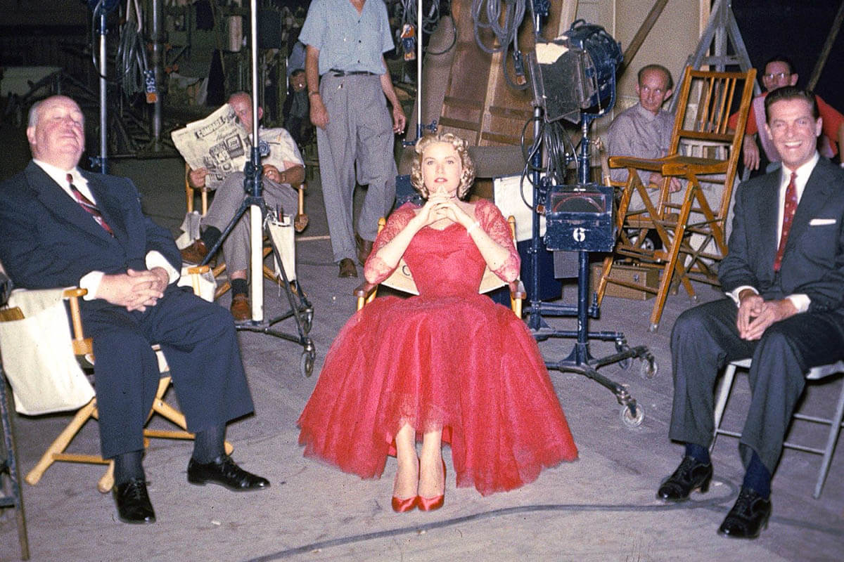 Alfred Hitchcock, actress Grace Kelly, and actor Robert Cummings on set.